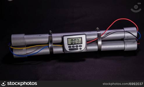 Pipe bomb with an lcd clock timer to trigger detonation on black background