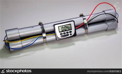 Pipe bomb with an lcd clock timer to trigger detonation on white background