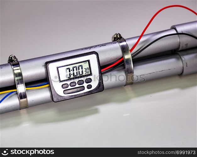 Pipe bomb with an lcd clock timer to trigger detonation on white background