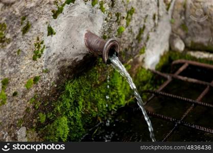 Pipe clean water pouring from a natural source&#xA;