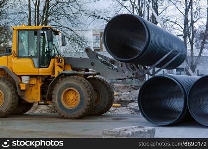 pipe, loader, forklift, bulldozer, heavy, work, diameter, large. forklift distributes plastic pipes of large diameter