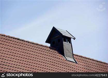Pipe of ventilation on a roof of tiles