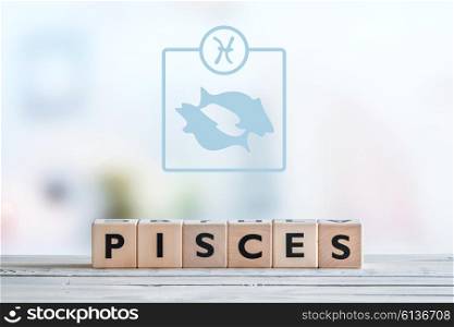 Pisces star sign on a wooden table