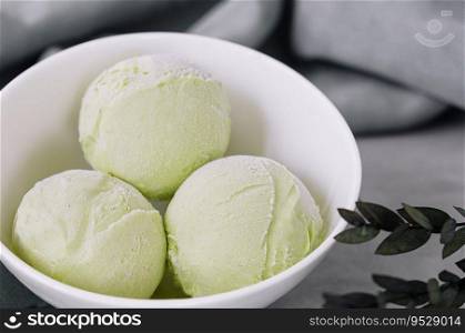 Pistachio ice cream scoops on a bowl