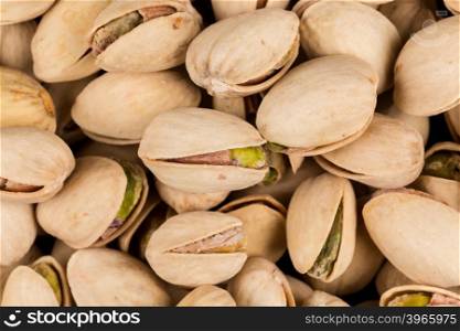 Pistachio nuts arranges as background close up