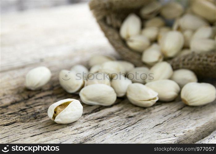 Pistachio nuts on wood background