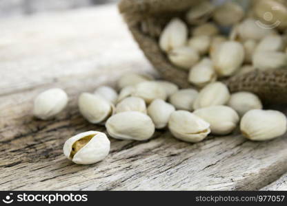 Pistachio nuts on wood background