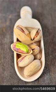 Pistachio nuts on wooden scoops