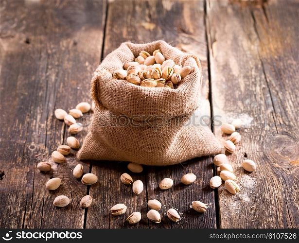 pistachios in a sack on wooden table
