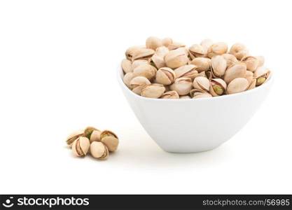 Pistachios in a white ceramics bowl isolated on white background