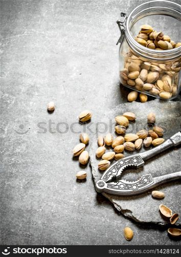 Pistachios in the jar with the Nutcracker. On the stone table.. Pistachios in the jar with the Nutcracker.