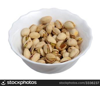 Pistachios on a plate on a white background, isolated