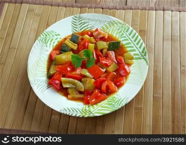 Pisto - Spanish dish . made of tomatoes, onions, eggplant or courgettes, green and red peppers and olive oil