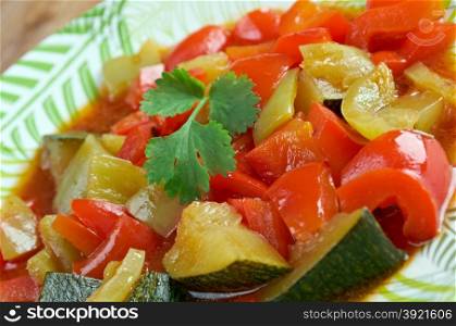 Pisto - Spanish dish . made of tomatoes, onions, eggplant or courgettes, green and red peppers and olive oil