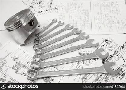 Piston and nut keys of different sizes lay on drawing
