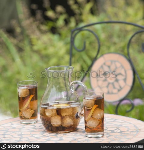 Pitcher and two glasses of ice tea on a table