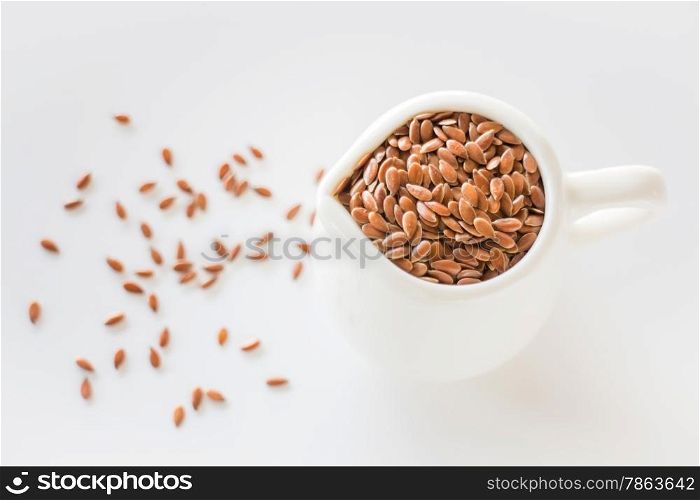 Pitcher of organic brown flaxseed, stock photo