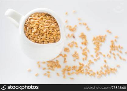 Pitcher of organic gold flaxseed, stock photo