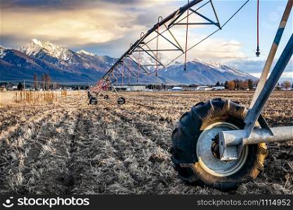 Pivot Irrigation Line on Dry Feild in Ronan Montana with Snow Peaked Mission Mountains in the Background