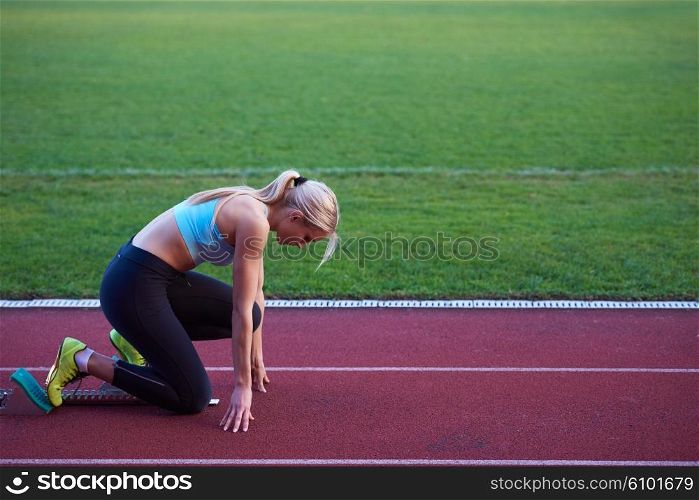 pixelated design of woman sprinter leaving starting blocks on the athletic track. Side view. exploding start