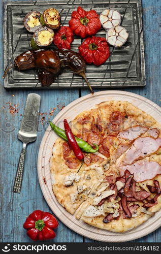 pizza and baked vegetables. Pizza with beef and roasted red pepper with eggplant