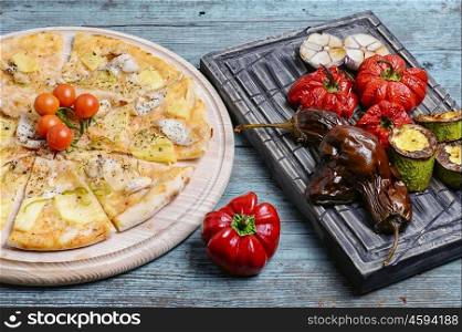 pizza and baked vegetables. Pizza with beef and roasted red pepper with eggplant