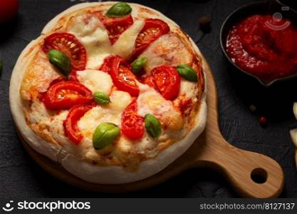 Pizza and sauce homemade cooking with ingredients at table. Pizza on tabletop background. Recipe concept in kitchen