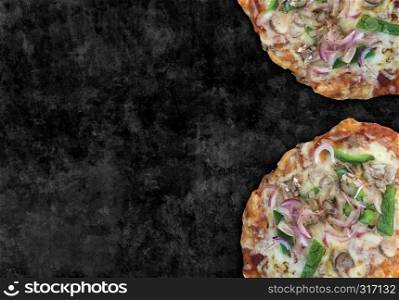 Pizza background with rustic baked dough as Italian cooking from a pizzeria or home cooking,with fresh raw chopped ingredients as authentic Italy cuisine food on black.