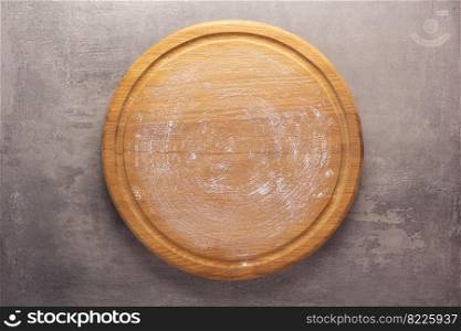 Pizza board at stone background top table. Wooden cutting board