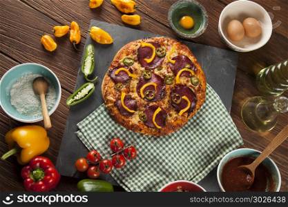 Pizza cooking ingredients. Fresh italian pizza on wood. Fast food