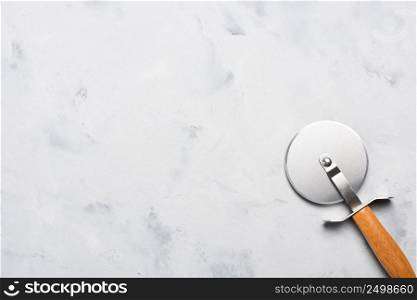 Pizza cutter with wooden handle on table top view