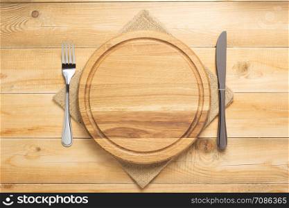 pizza cutting board and napkin at rustic wooden table plank background, top view