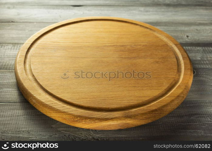 pizza cutting board at rustic wooden background