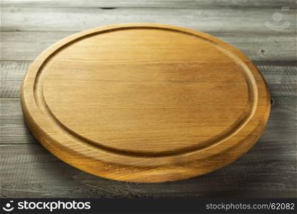 pizza cutting board at rustic wooden background