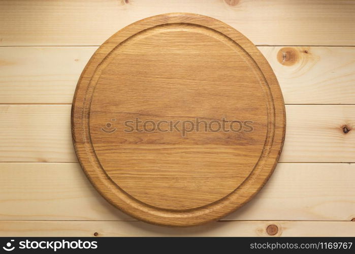 pizza cutting board at rustic wooden plank background, top view