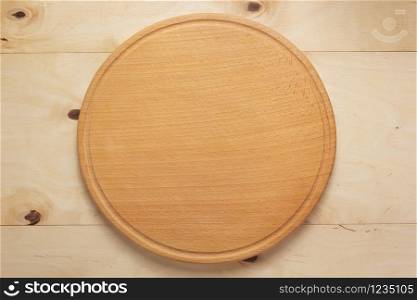 pizza cutting board at rustic wooden plank background, top view