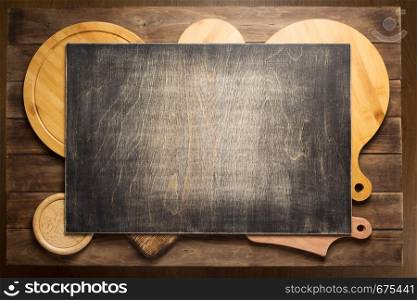 pizza cutting board at rustic wooden plank board background, top view