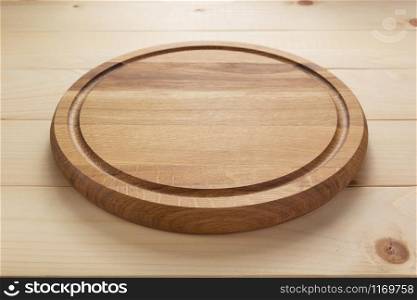pizza cutting board at rustic wooden table plank background, front view