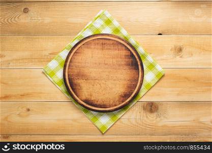pizza cutting board at rustic wooden table plank background, top view