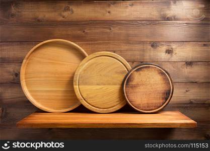 pizza cutting board at shelf on brown wooden background