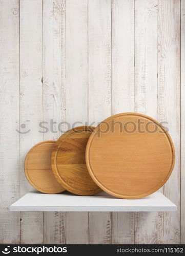 pizza cutting board at shelf on white wooden background