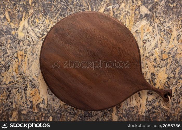 Pizza cutting board at wooden osb background top table. Empty pizza board at wood