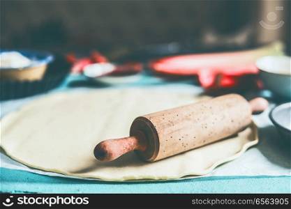 Pizza Dough and rolling pin on kitchen table