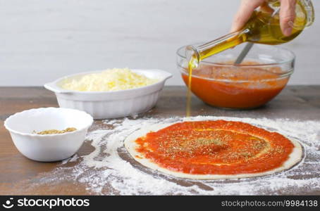 pizza dough with fresh tmato sauce and oregano. Italian traditional recipe of pizza
