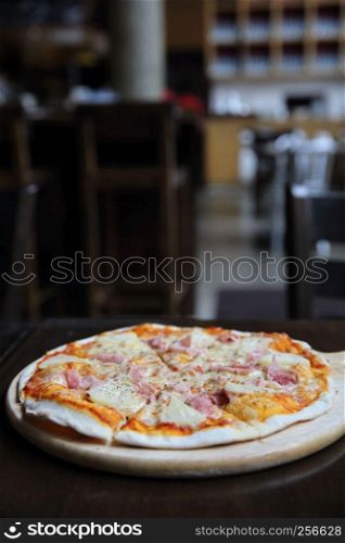 pizza hawaiian , pizza with pineapple and ham with cheese and tomatoes sauce on wood background , italian food