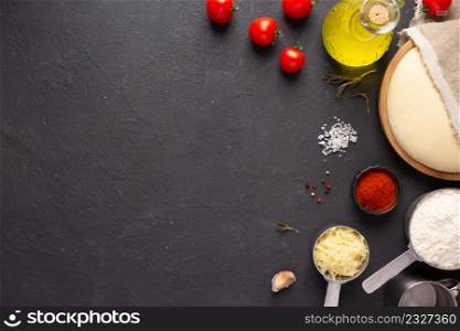 Pizza homemade cooking or baking on table. Dough pizza at slate tabletop background. Recipe concept in kitchen