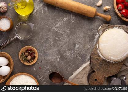 Pizza homemade cooking or baking on table. Dough pizza at tabletop background. Recipe concept in kitchen