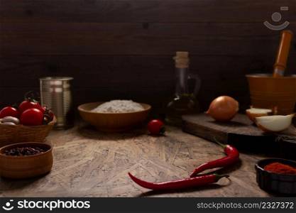 Pizza ingredient for homemade cooking or baking on table. Flour at wooden tabletop background. Recipe concept in kitchen
