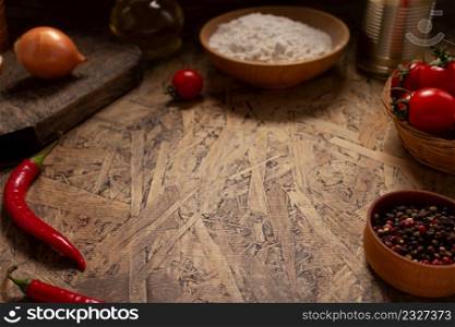 Pizza ingredient for homemade cooking or baking on table. Flour at wooden tabletop background. Recipe concept in kitchen