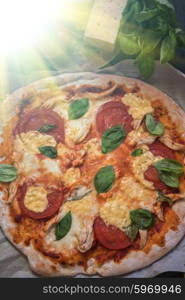 pizza margarita closeup. rustic italian pizza with mozzarella cheese tomato and basil leaves